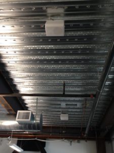 metal ceiling with speakers attached for audio video installation