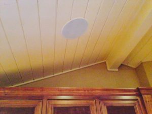 round ceiling speaker installed in pitched ceiling - audio video installation